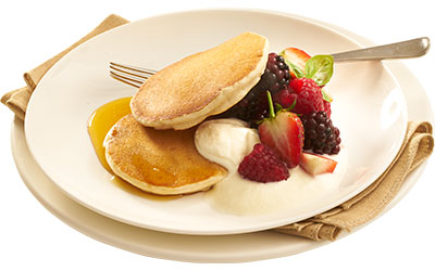 Buttermilk pancaes served with fruit, yoghurt and honey
