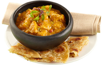 Chicken curry served with paratha