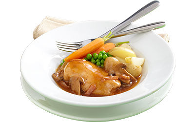 Coq au vin served with vegetables and new potatoes